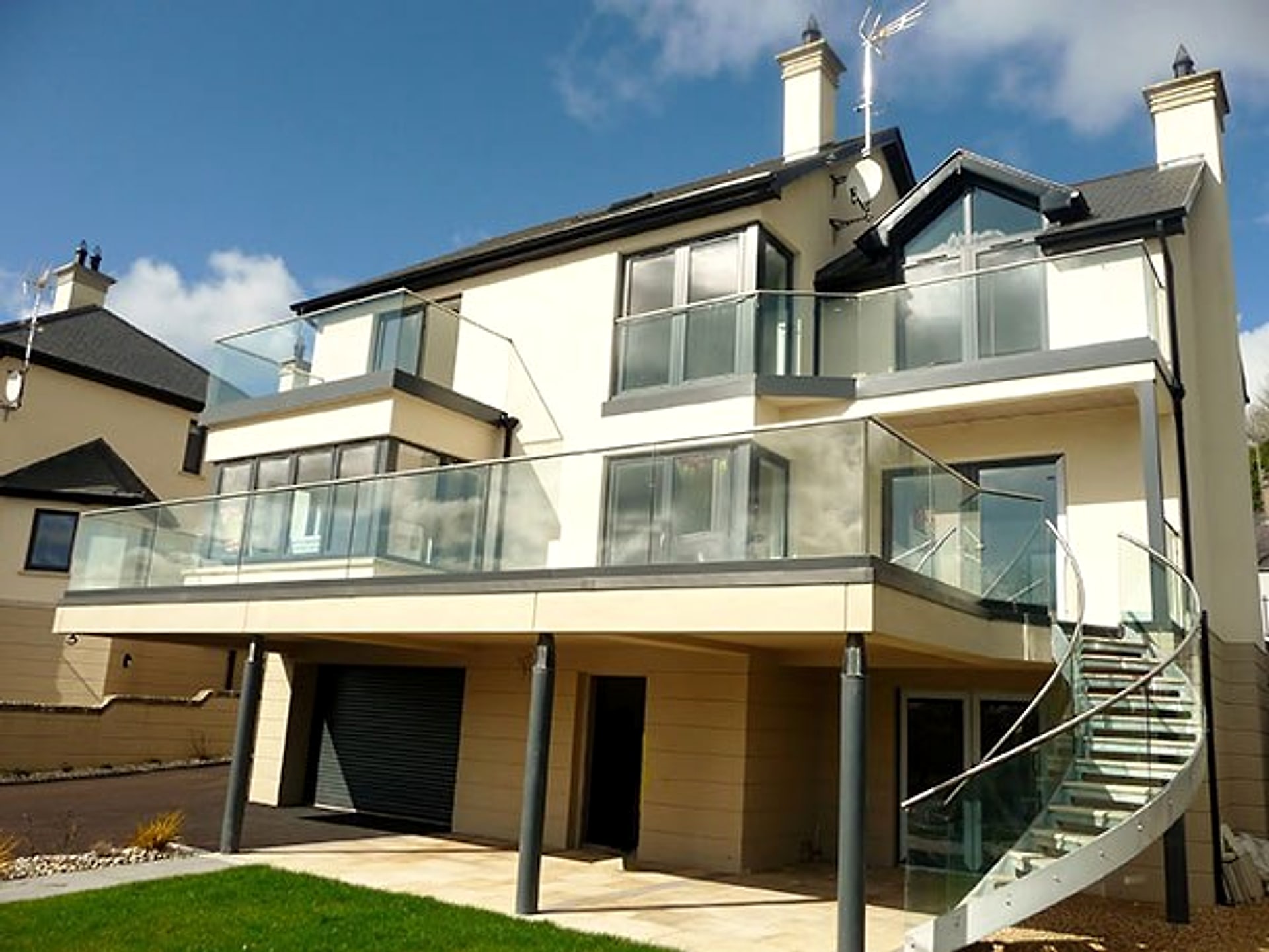 M E Crowe new-build residential home with glass-balustrade balconies, County Antrim
