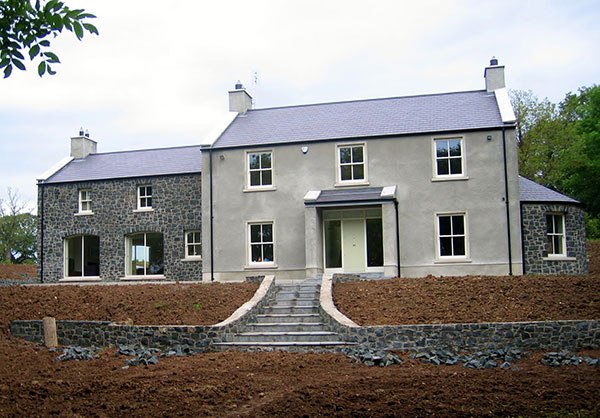 M E Crowe rendered and basalt-stone farmhouse new build, County Antrim